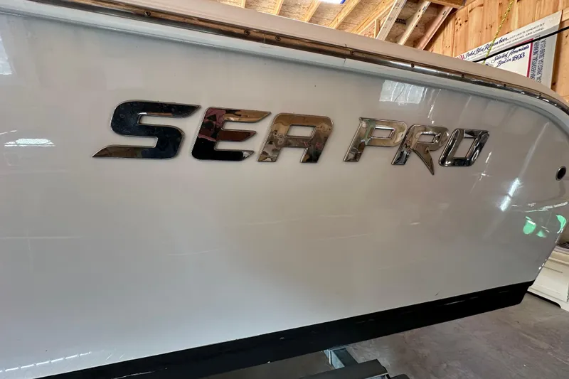 Slide: The Image of 2019 Sea Pro 239 Deep V CC boat with chrome logo in a wooden garage. - 14