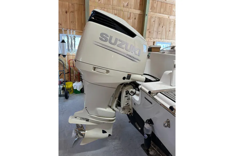 Slide: The Image of 2019 Sea Pro 239 Deep V CC with Suzuki outboard motor in a wooden garage. - 3