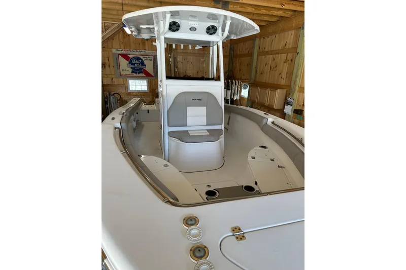 Slide: The Image of 2019 Sea Pro 239 Deep V CC boat in a wooden garage, showcasing spacious seating. - 5