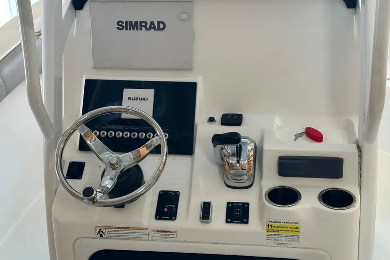 Slide: The Image of 2019 Sea Pro 239 Deep V CC boat console with Simrad display and Suzuki controls. - 9