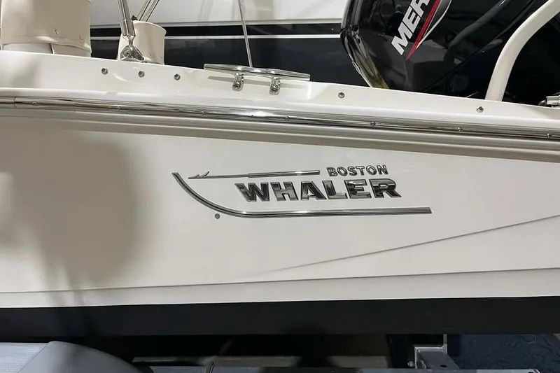 Slide: The Image of 2023 Boston Whaler 160 Super Sport boat side view with logo and Mercury engine. - 10