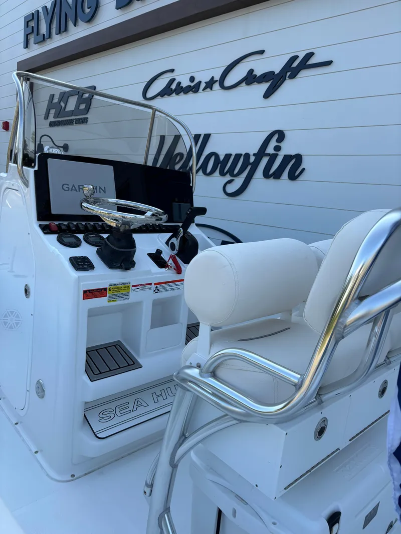 Slide: The Image of 2026 Sea Hunt Ultra 219 boat console with Garmin navigation, white seating, and chrome details. - 4