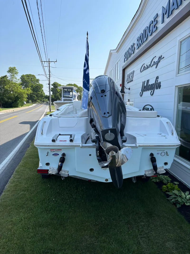 Slide: The Image of 2026 Sea Hunt Ultra 219 boat displayed outside a marine dealership. - 5