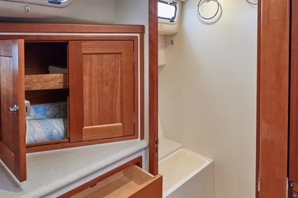 Slide: The Image of 2018 MJM 40z yacht interior with wooden cabinetry and storage space. - 11