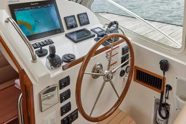Slide: The Image of Helm of 2018 MJM 40z boat with navigation equipment and wooden steering wheel. - 12
