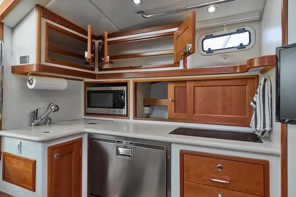 Slide: The Image of Luxurious 2018 MJM 40z yacht kitchen with wood cabinetry and modern appliances. - 2
