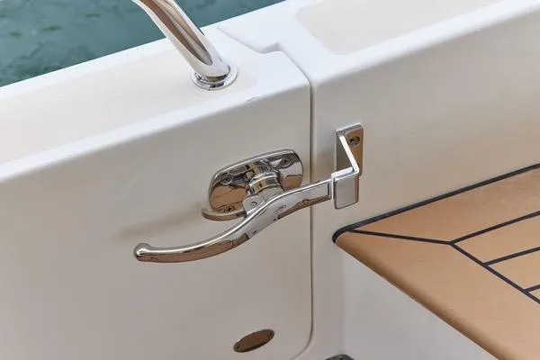Slide: The Image of Chrome handle on 2018 MJM 40z boat, featuring teak deck detail. - 28