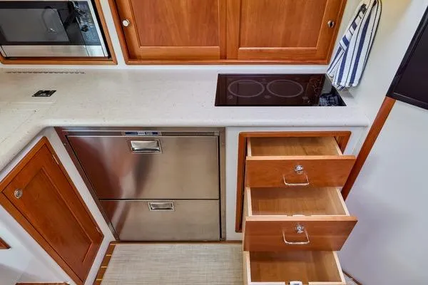 Slide: The Image of Modern kitchen in 2018 MJM 40z yacht with stove, drawers, and stainless steel appliances. - 3