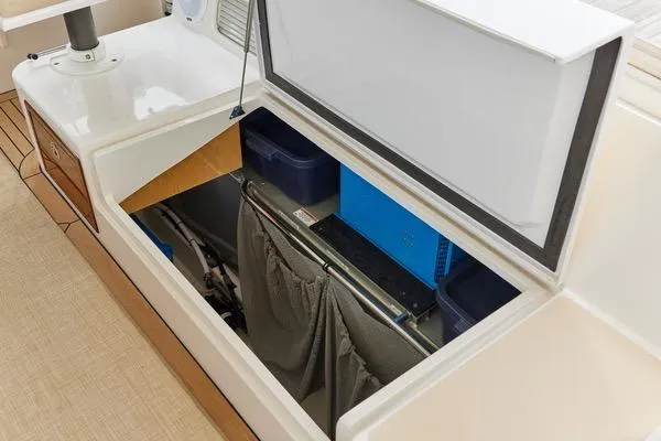 Slide: The Image of Open storage compartment on a 2018 MJM 40z boat, revealing organized interior space. - 34