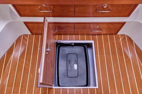 Slide: The Image of 2018 MJM 40z yacht interior with wooden flooring and storage compartment. - 37