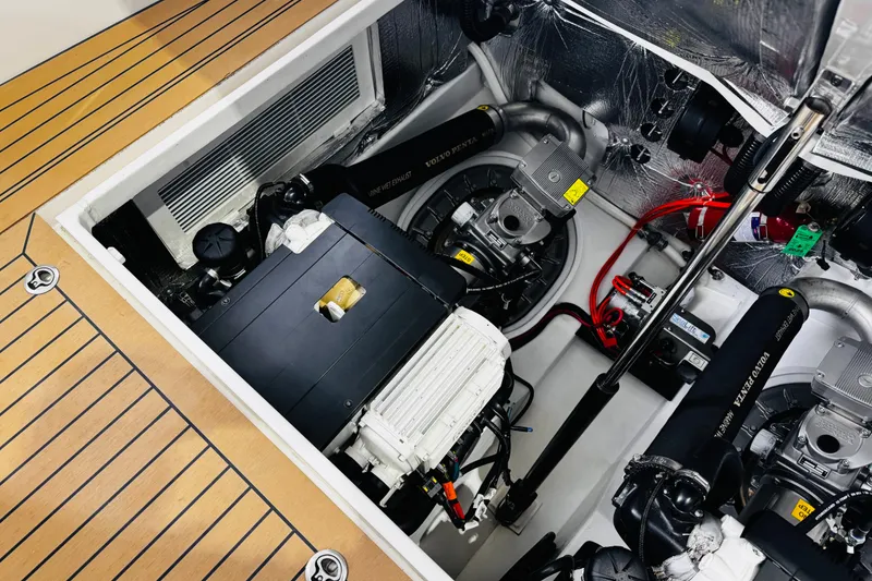 Slide: The Image of Engine compartment of a 2018 MJM 40z boat, showcasing mechanical components and wiring. - 42