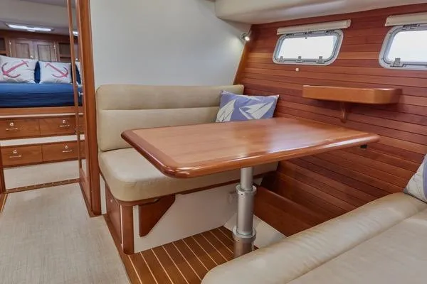 Slide: The Image of Interior of 2018 MJM 40z yacht with wooden dining area and cozy seating. - 5