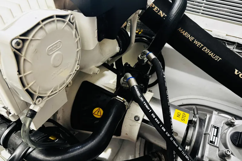 Slide: The Image of Engine components of a 2018 MJM 40z boat, featuring marine wet exhaust system. - 54