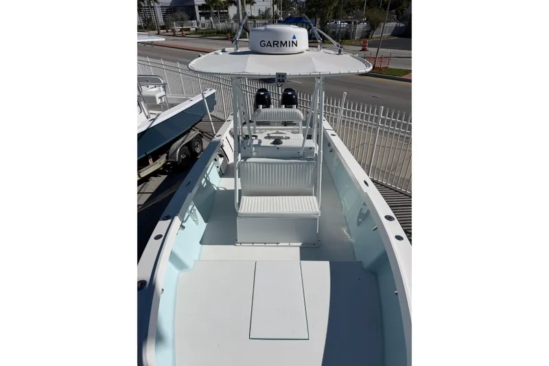 Slide: The Image of 2005 Albury Brothers 23 boat with Garmin equipment, docked near a fence. - 3