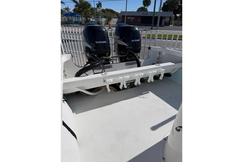 Slide: The Image of 2005 Albury Brothers 23 boat with dual Suzuki outboard engines, docked outdoors. - 9