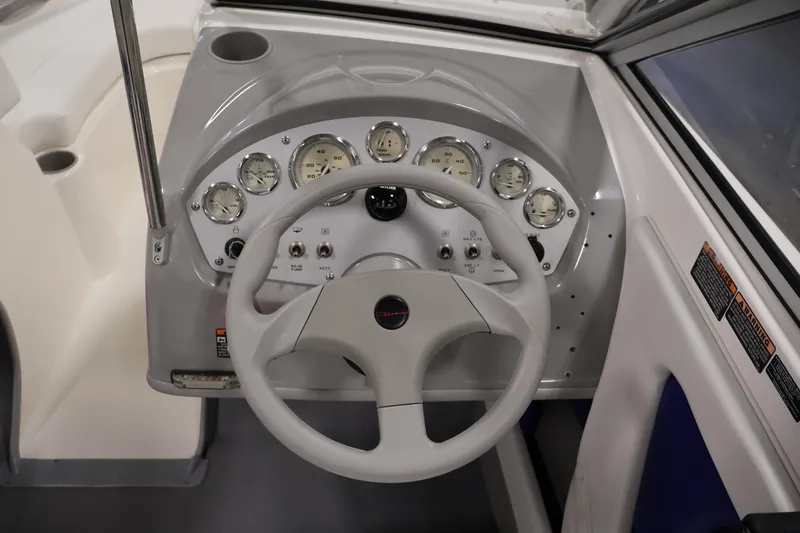 Slide: The Image of 2006 Bayliner 195 Bowrider dashboard with steering wheel and gauges. - 14