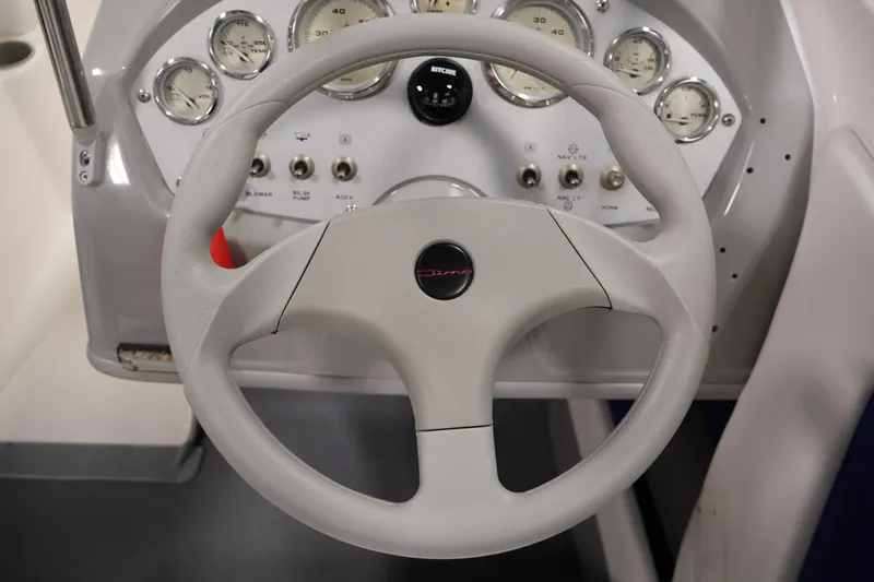 Slide: The Image of Steering wheel and dashboard of a 2006 Bayliner 195 Bowrider boat. - 15