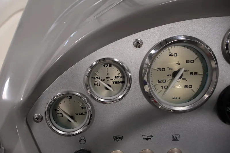 Slide: The Image of Dashboard gauges of a 2006 Bayliner 195 Bowrider boat, showing speed, temperature, and voltage. - 16