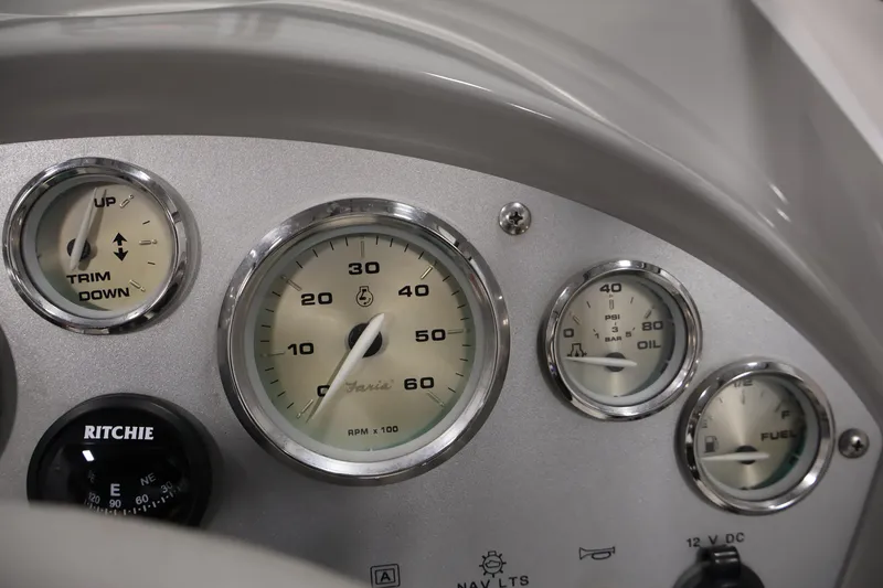 Slide: The Image of Dashboard of a 2006 Bayliner 195 Bowrider with gauges and compass. - 17