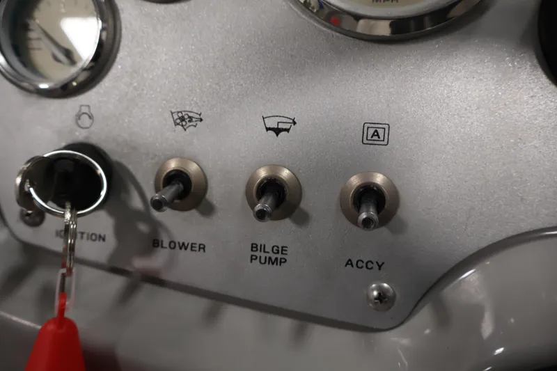 Slide: The Image of Dashboard controls of a 2006 Bayliner 195 Bowrider boat, featuring ignition and switches. - 19