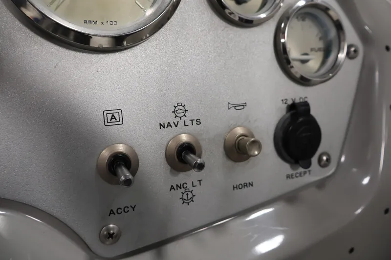 Slide: The Image of Dashboard controls of a 2006 Bayliner 195 Bowrider boat, featuring switches and gauges. - 20