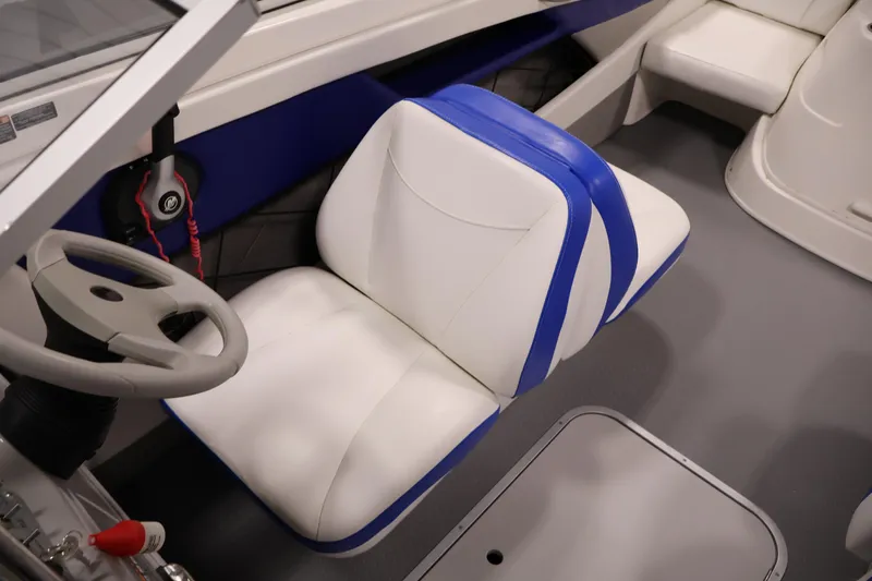 Slide: The Image of 2006 Bayliner 195 Bowrider interior with blue and white seating and steering wheel. - 22
