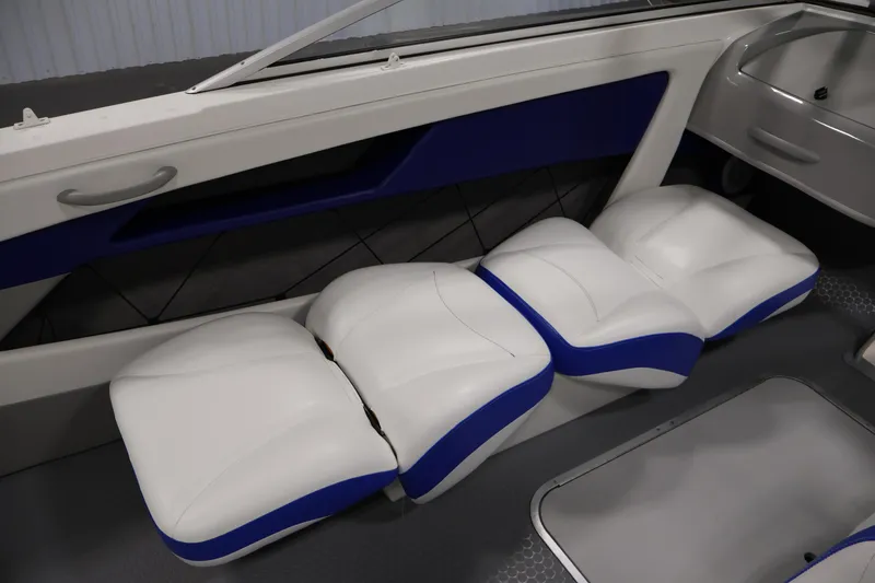 Slide: The Image of 2006 Bayliner 195 Bowrider interior with white and blue cushioned seating. - 29