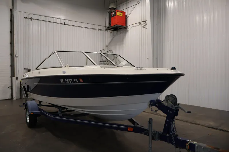 Slide: The Image of 2006 Bayliner 195 Bowrider boat on trailer in indoor storage facility. - 3