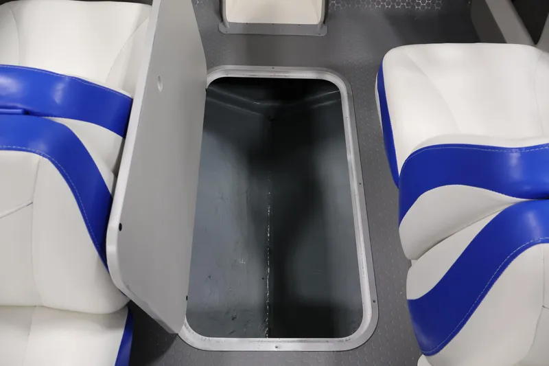 Slide: The Image of 2006 Bayliner 195 Bowrider interior storage compartment with blue and white seating. - 31