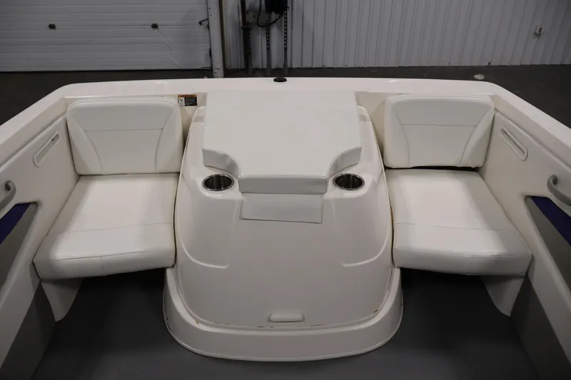 Slide: The Image of 2006 Bayliner 195 Bowrider interior with white seating and cup holders. - 34