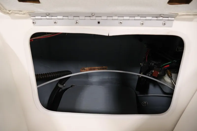 Slide: The Image of 2006 Bayliner 195 Bowrider interior compartment with wiring and components visible. - 38