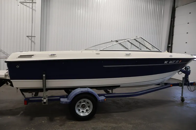Slide: The Image of 2006 Bayliner 195 Bowrider boat on trailer in indoor storage facility. - 4