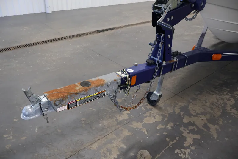Slide: The Image of Trailer hitch of a 2006 Bayliner 195 Bowrider with visible rust and safety chains. - 45