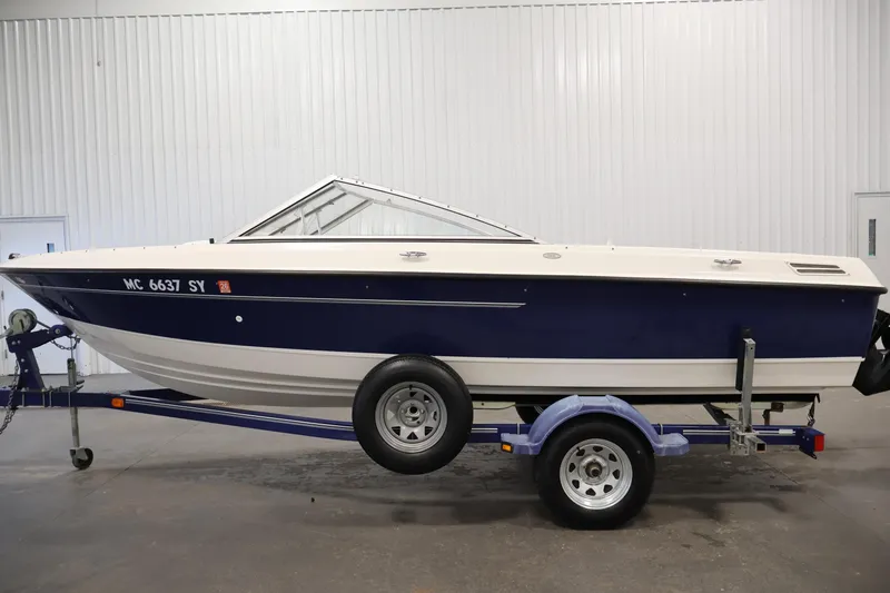 Slide: The Image of 2006 Bayliner 195 Bowrider boat on trailer in indoor setting. - 8