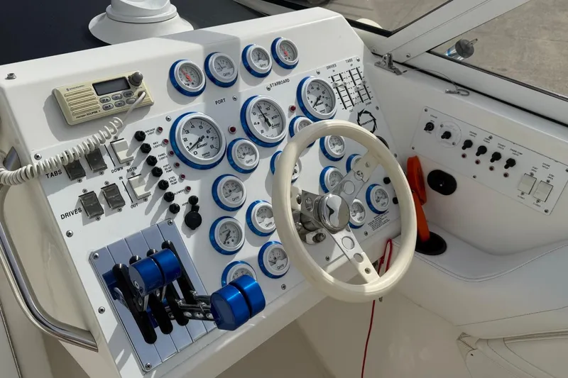 Slide: The Image of Control panel of a 2000 Fountain 38 Lightning boat with gauges and steering wheel. - 10