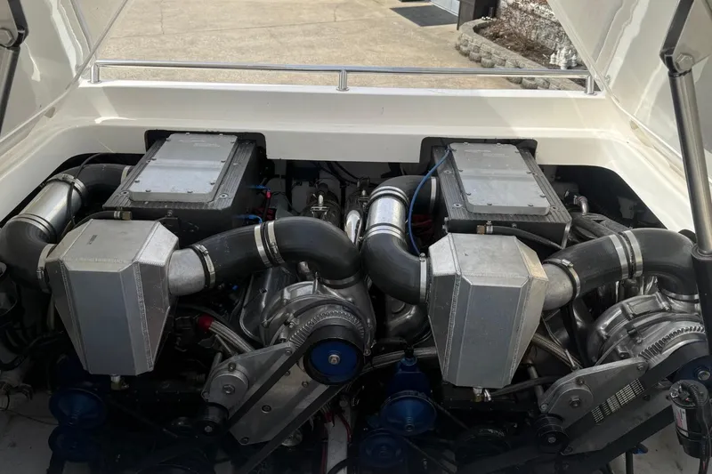Slide: The Image of Engine compartment of a 2000 Fountain 38 Lightning boat, showcasing dual engines and components. - 11