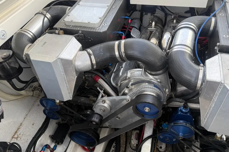 Slide: The Image of Engine compartment of a 2000 Fountain 38 Lightning boat, showcasing intricate mechanical components. - 13