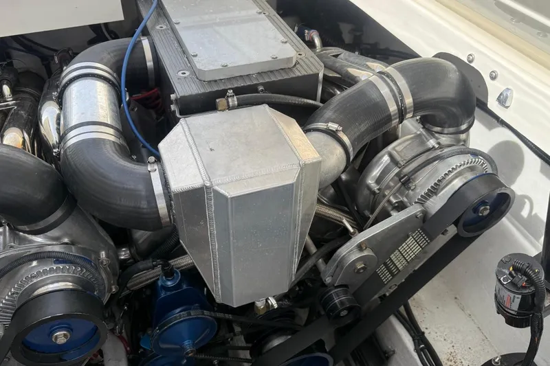Slide: The Image of Engine compartment of a 2000 Fountain 38 Lightning boat, showcasing mechanical components. - 15