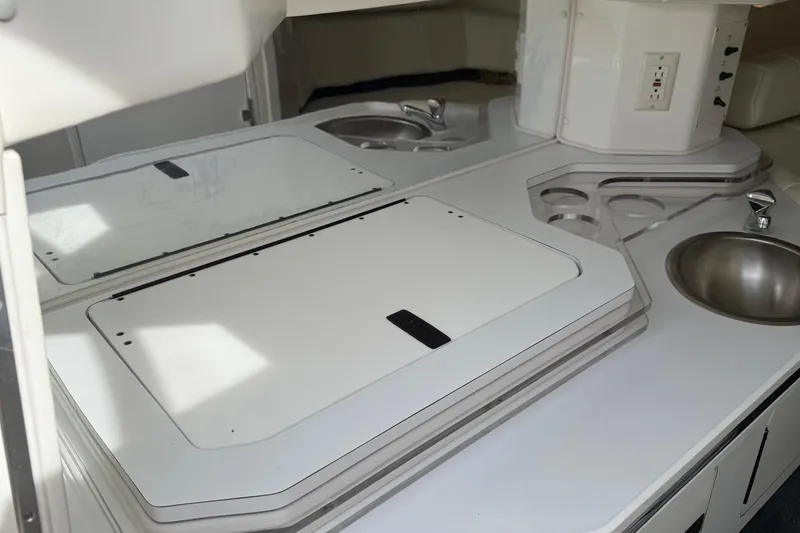 Slide: The Image of Interior of 2000 Fountain 38 Lightning boat with sleek kitchen area and stainless steel sink. - 17