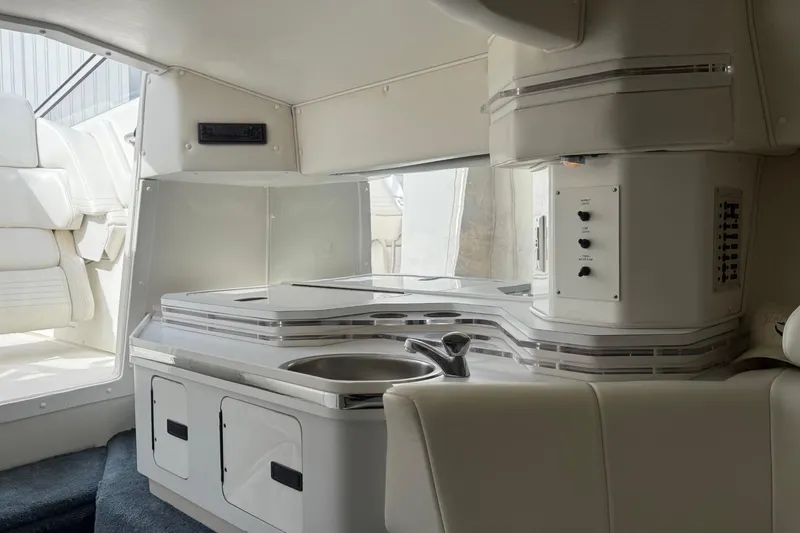 Slide: The Image of Interior of 2000 Fountain 38 Lightning boat with sleek white cabinetry and seating. - 22