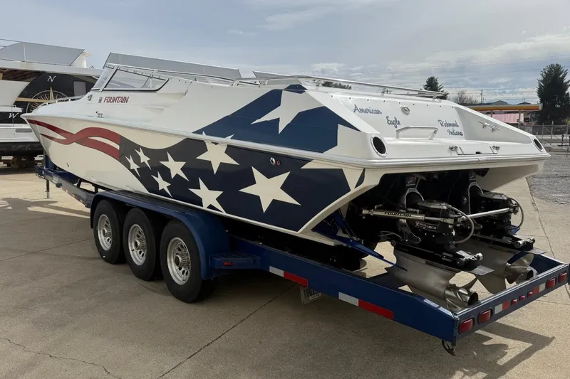 Slide: The Image of 2000 Fountain 38 Lightning boat with American flag design on a trailer. - 3