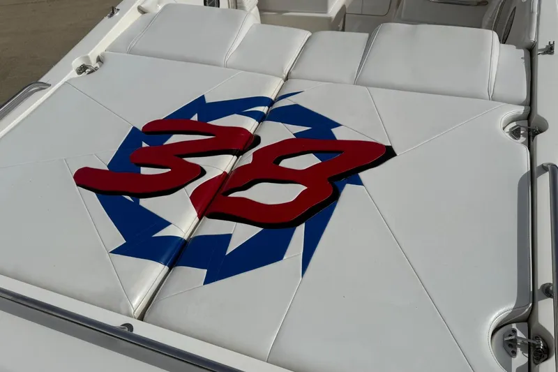 Slide: The Image of Fountain 38 Lightning 2000 boat seat with red "38" and blue star design. - 6