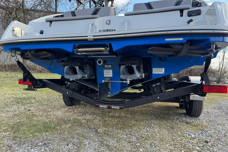 Slide: The Image of 2024 Yamaha Boats 222XE on trailer, rear view showing dual engines and hull design. - 8