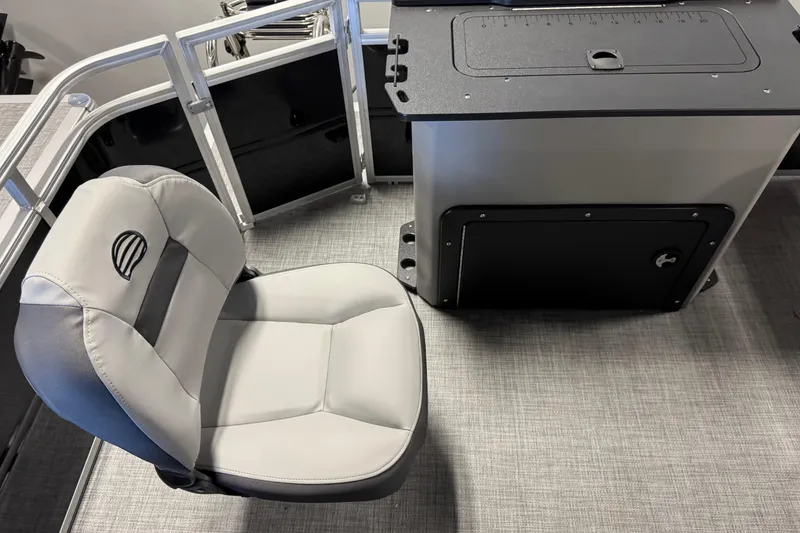 Slide: The Image of 2026 Sun Tracker SportFish 20 DLX boat interior with gray seating and storage compartment. - 12