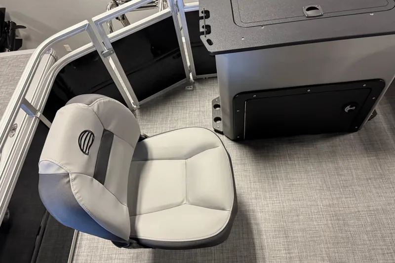 Slide: The Image of 2026 Sun Tracker SportFish 20 DLX boat interior with cushioned seat and storage compartment. - 14