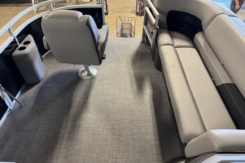 Slide: The Image of 2026 Sun Tracker SportFish 20 DLX interior with gray seating and carpet flooring. - 15