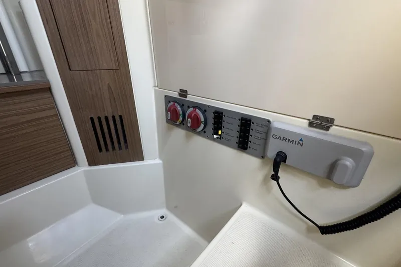 Slide: The Image of 2023 Chris-Craft Catalina 30 interior with Garmin panel and wooden accents. - 13