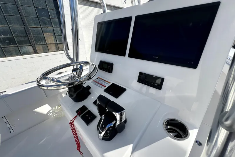 Slide: The Image of 2026 Contender 25 Tournament boat dashboard with dual screens and steering wheel. - 10