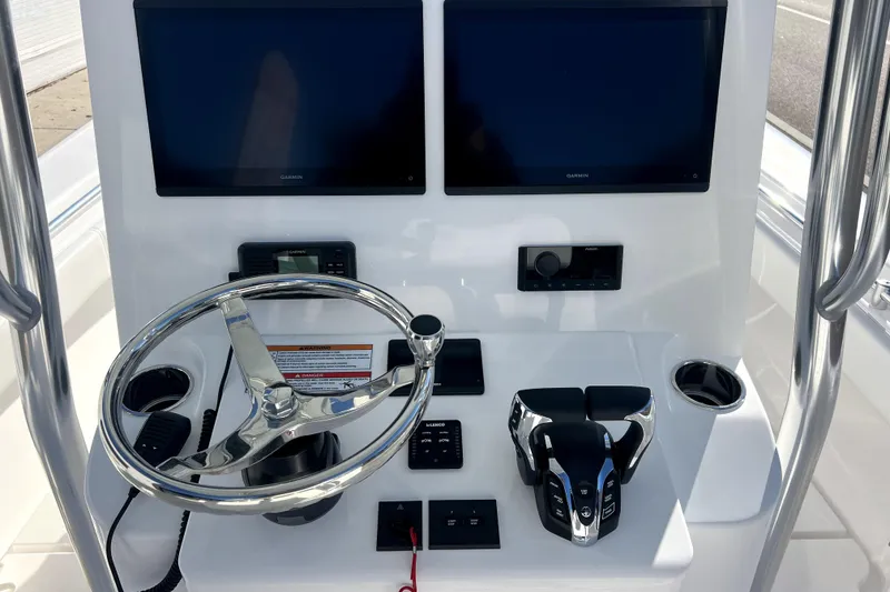 Slide: The Image of 2026 Contender 25 Tournament boat dashboard with dual Garmin screens and modern controls. - 11