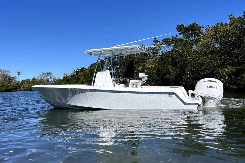 Slide: The Image of 2026 Contender 25 Tournament boat on water, featuring Yamaha engine, clear blue sky backdrop. - 2